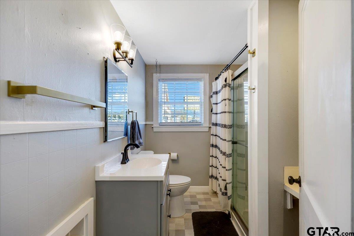 10286 US Highway 69 North Tyler, TX 75706 - Photo 25 of 31 a bathroom with a sink a mirror and shower