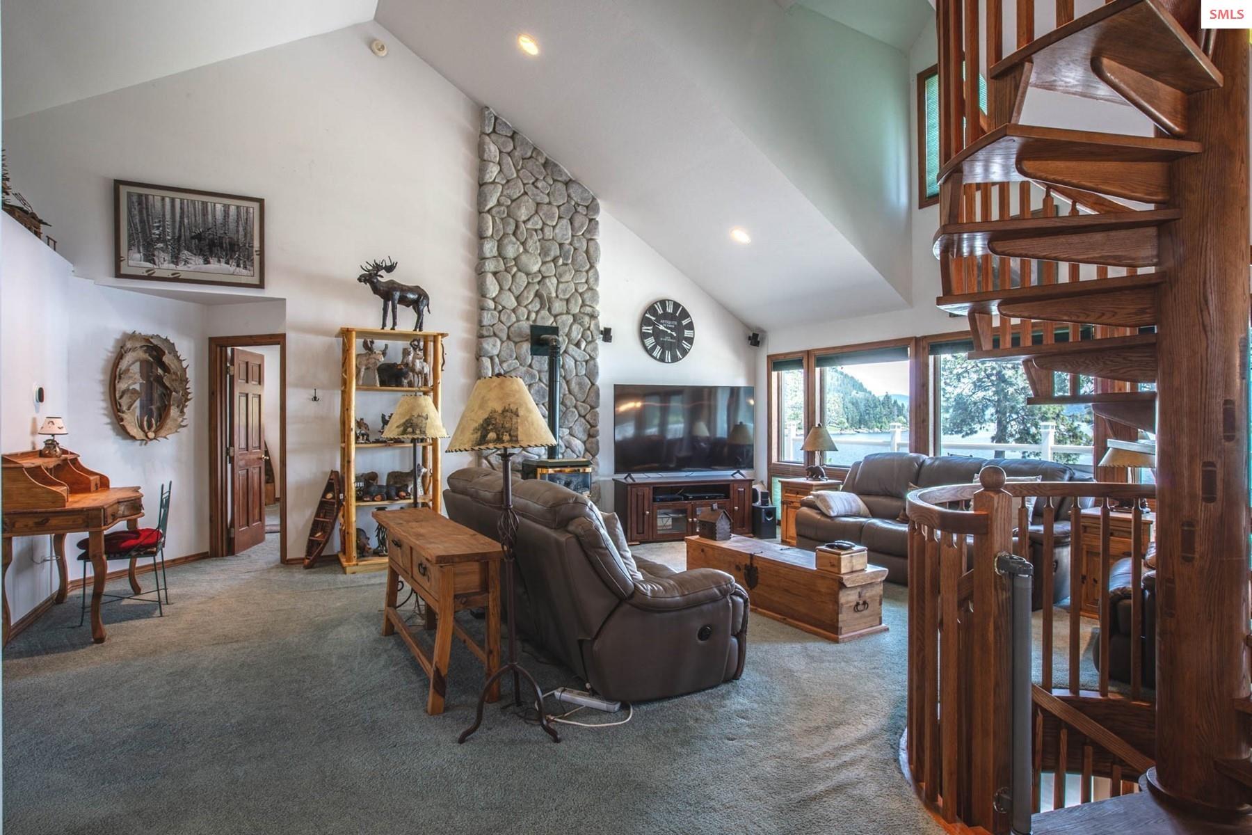 433 Campbell Point Road Laclede, ID 83841 - Photo 16 of 70 Floor to ceiling rock back-ground for propane stove fireplace