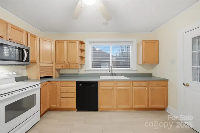 a kitchen with stainless steel appliances granite countertop a stove sink and microwave