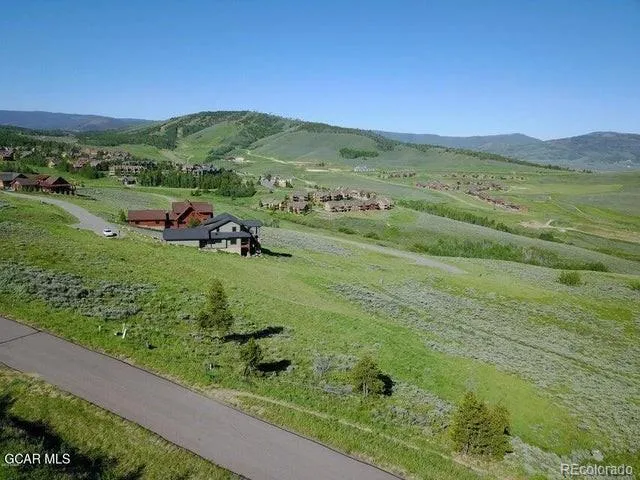 a view of a lush green hillside and houses