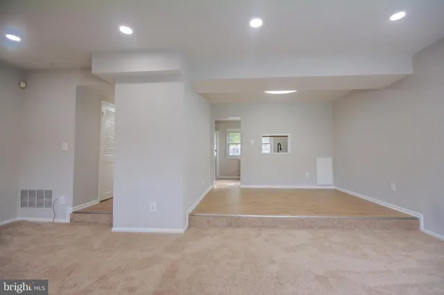 an empty room with windows and closet