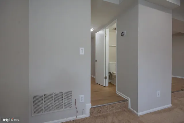 a view of a hallway with wooden shelves