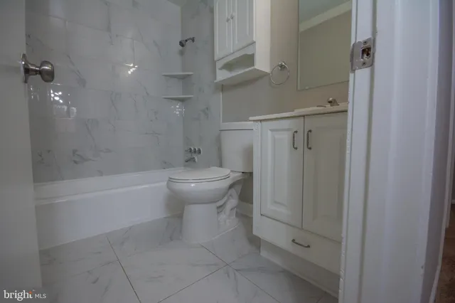 a bathroom with a toilet a sink and shower