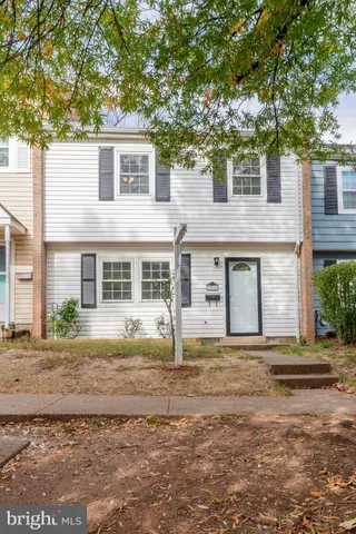 a house that has a tree in front of it