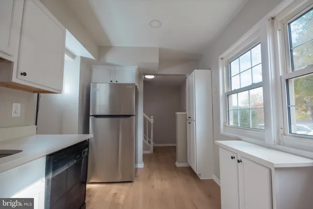 a kitchen with stainless steel appliances a refrigerator and a stove