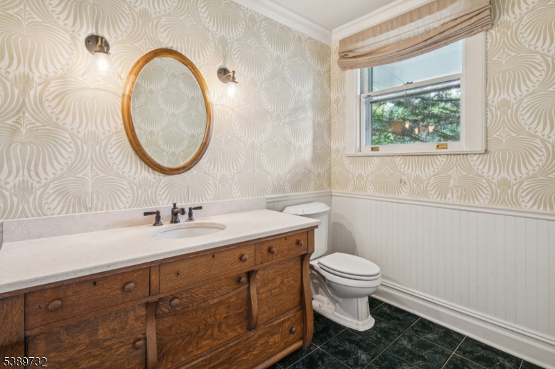 17 Three Gables Road Morristown, NJ 07960 - Photo 16 of 43 a bathroom with a granite countertop toilet a sink and a mirror