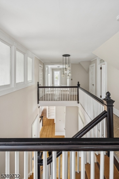17 Three Gables Road Morristown, NJ 07960 - Photo 32 of 43 a view of a hallway to a livingroom with wooden floor and stairs