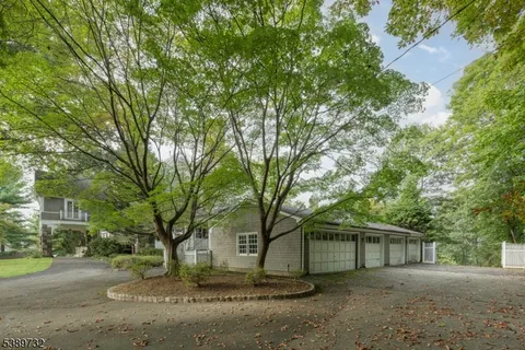 a view of a house with a large tree
