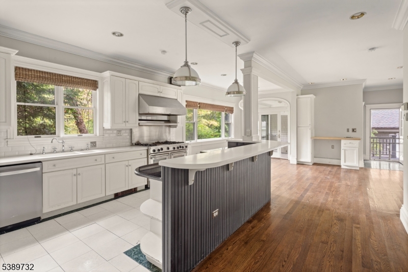 17 Three Gables Road Morristown, NJ 07960 - Photo 7 of 43 a kitchen with stainless steel appliances granite countertop a lot of white cabinets and wooden floors