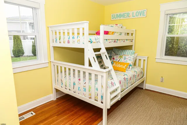 a view of a bedroom with baby bed and toys