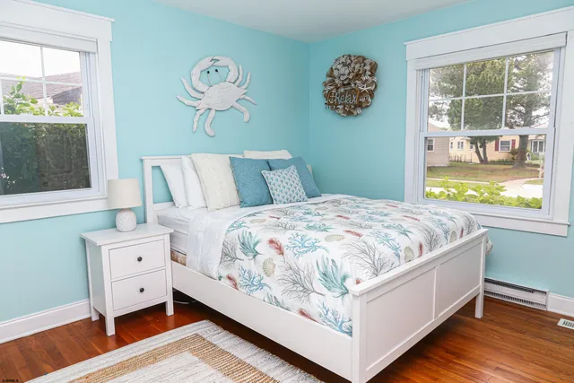 a large bed sitting in a bedroom next to a window