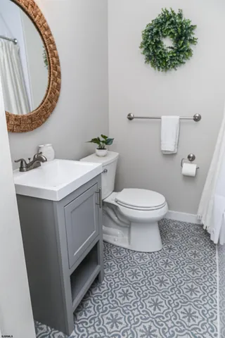 a bathroom with a sink toilet and mirror