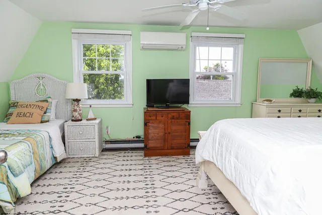 a bedroom with a bed and flat screen tv