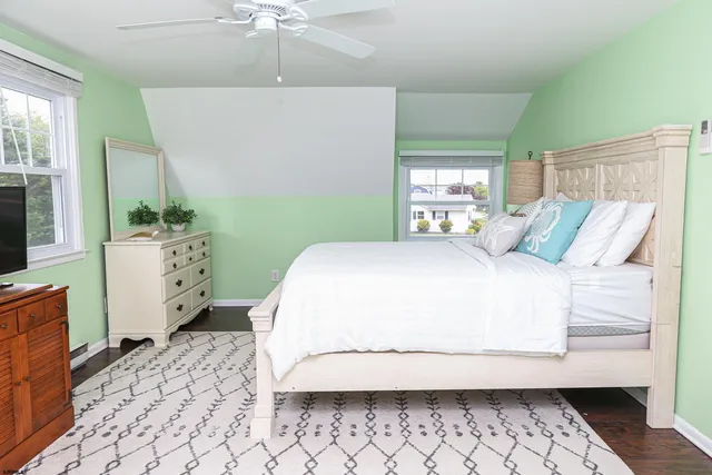 a bedroom with a large bed and a window