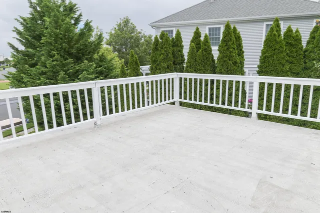 a view of a house with a yard and potted plants