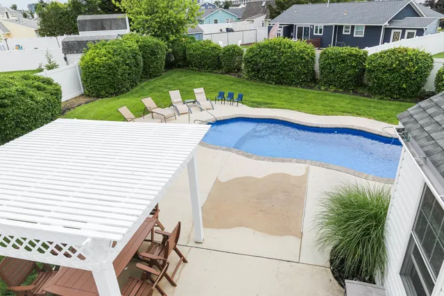 a view of a patio with a table chairs and backyard