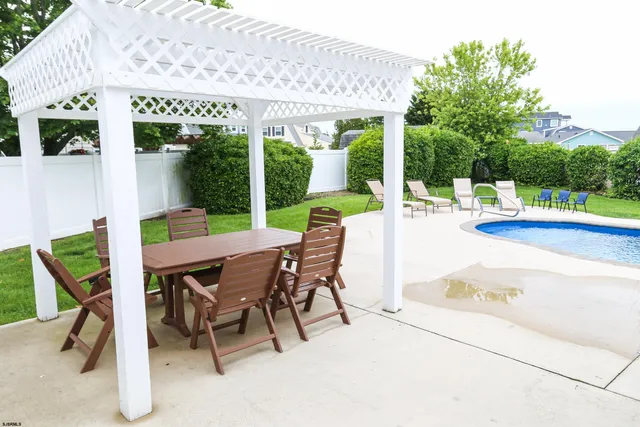 a view of a house with backyard porch and sitting area