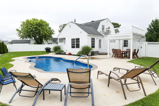a view of a backyard with swimming pool