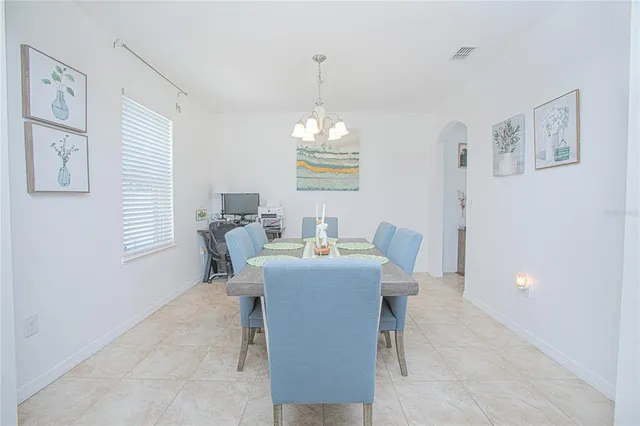 a view of a dining room with furniture large windows and wooden floor