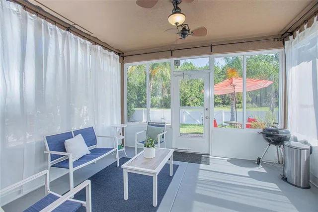 a view of a backyard with chairs and table