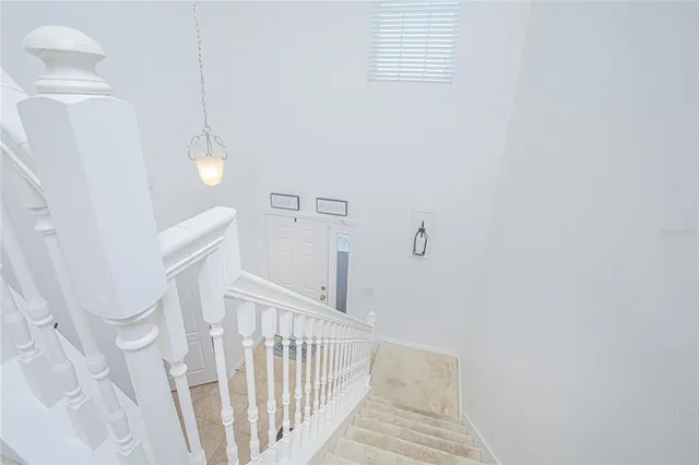 a spacious bedroom with a bed and a chandelier