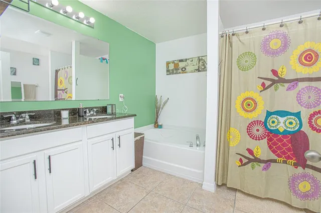 a bedroom with a bed furniture and a flat tv screen