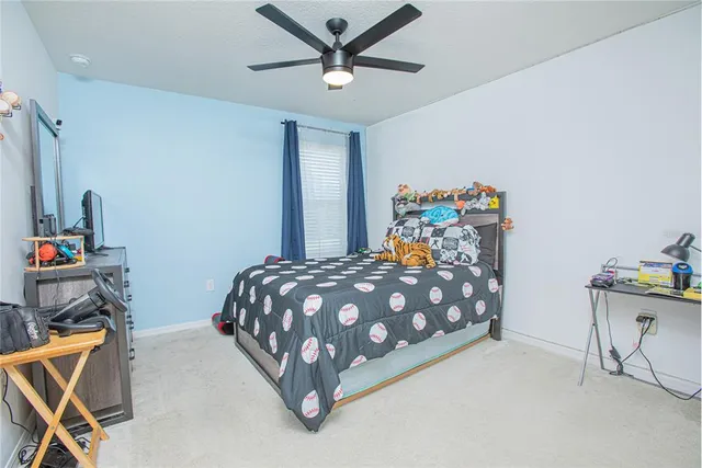 a bathroom with a granite countertop sink a toilet and a mirror
