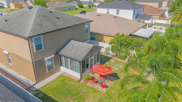 an aerial view of a house with pool and ocean view