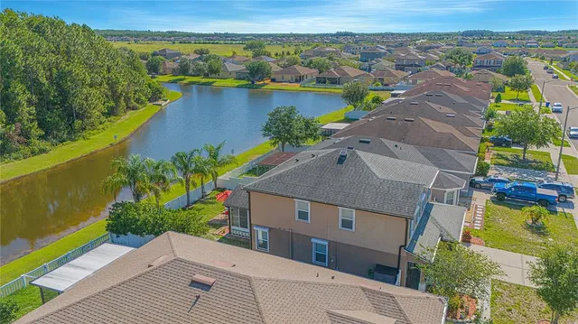 an aerial view of a house with garden space and lake view