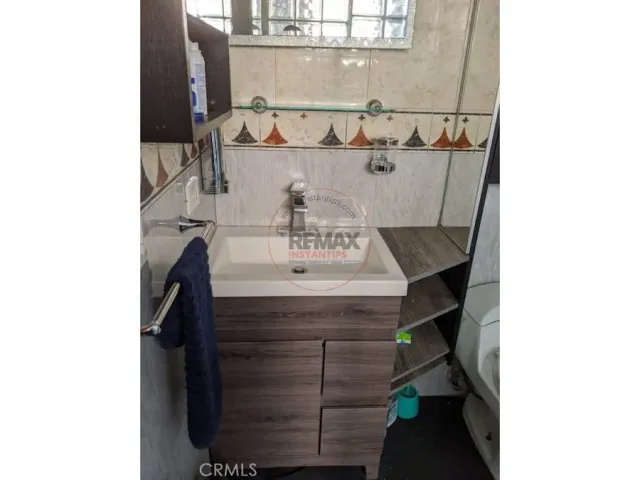 a bedroom with a bed and cabinet