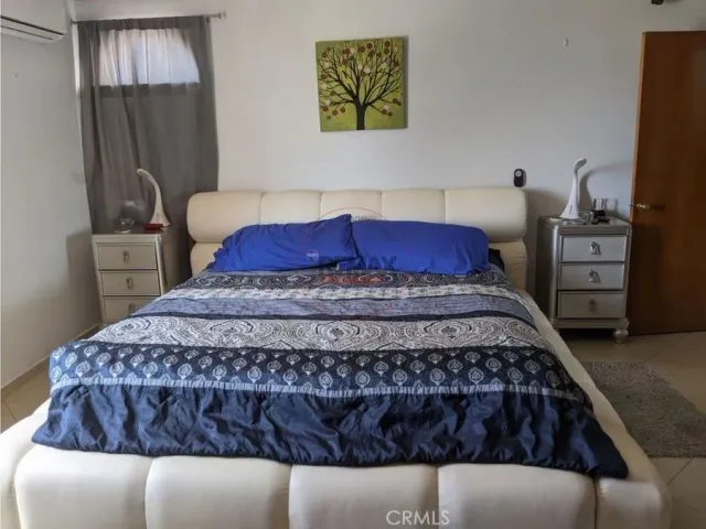 a dining room with furniture and a window