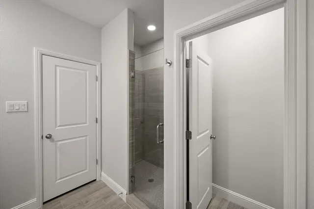 a bathroom with a shower and a glass door