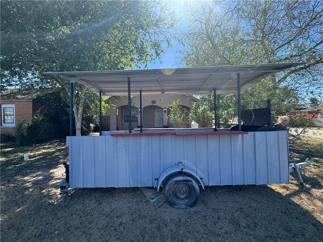 a view of a backyard with a small cabin and a chair