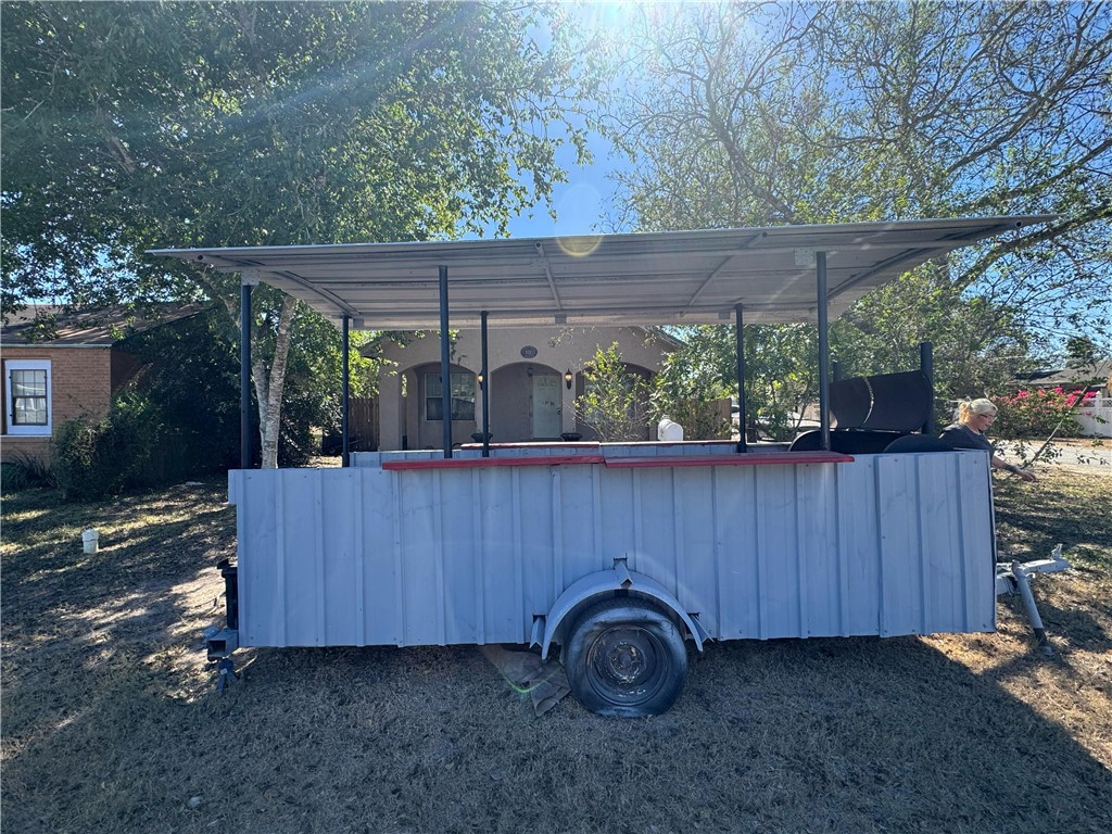 122 West 5th Street Alice, TX 78332 - Photo 2 of 40 a view of a backyard with a small cabin and a chair