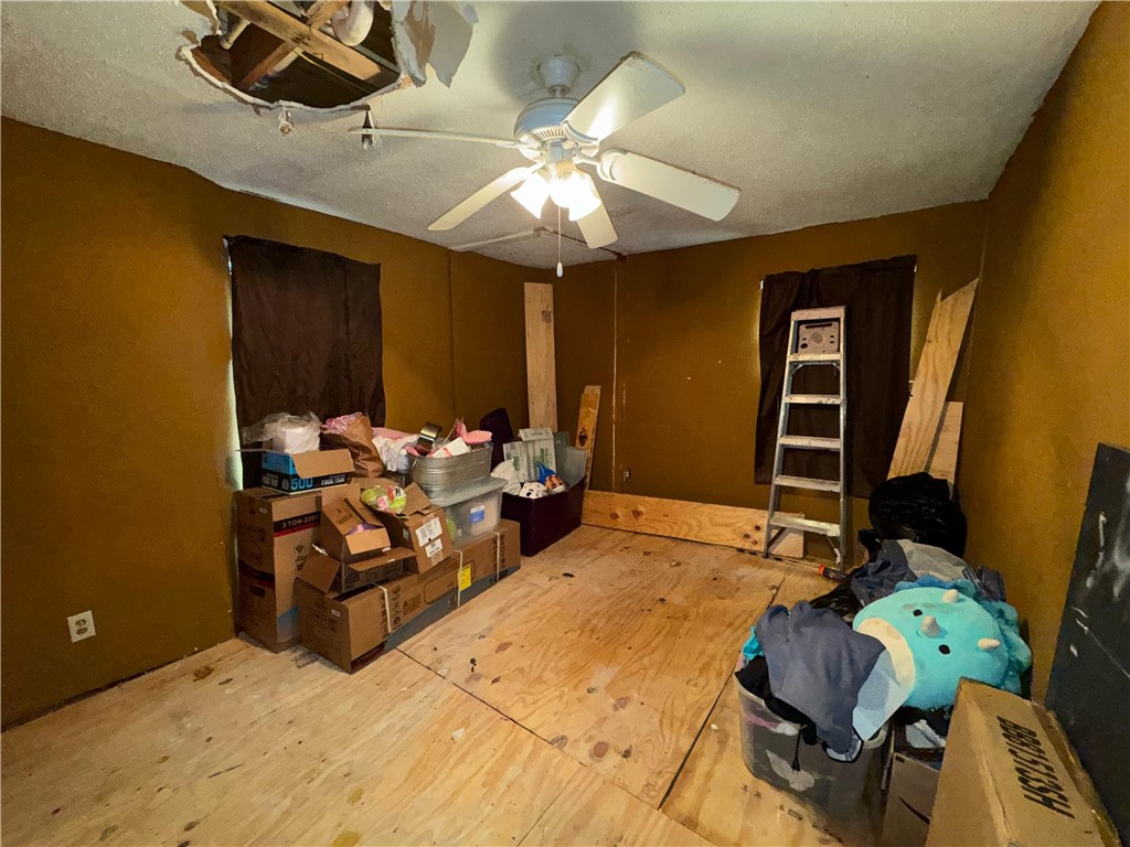 122 West 5th Street Alice, TX 78332 - Photo 24 of 40 a bedroom with furniture and a ceiling fan