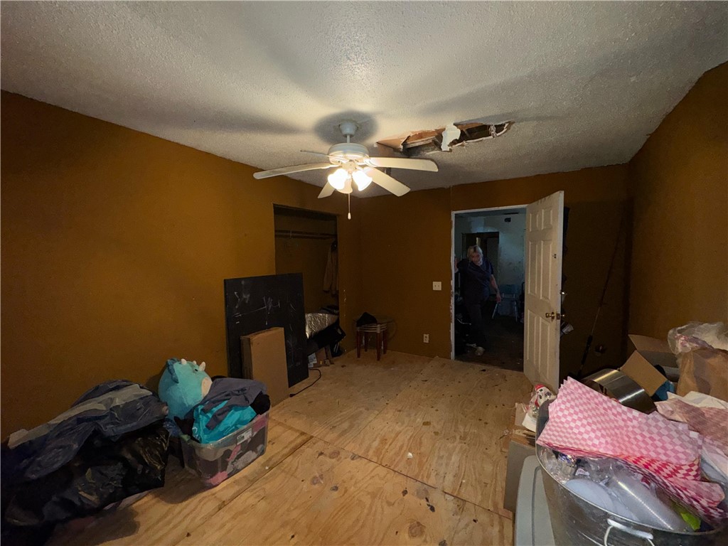 122 West 5th Street Alice, TX 78332 - Photo 27 of 40 a bedroom with furniture and a chandelier