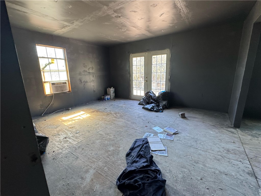 122 West 5th Street Alice, TX 78332 - Photo 37 of 40 wooden floor in an empty room with a window