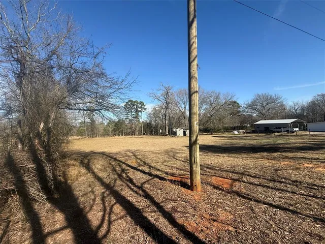 a view of a yard with wooden fence