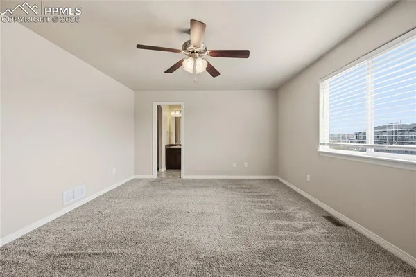 a view of an empty room with a fan