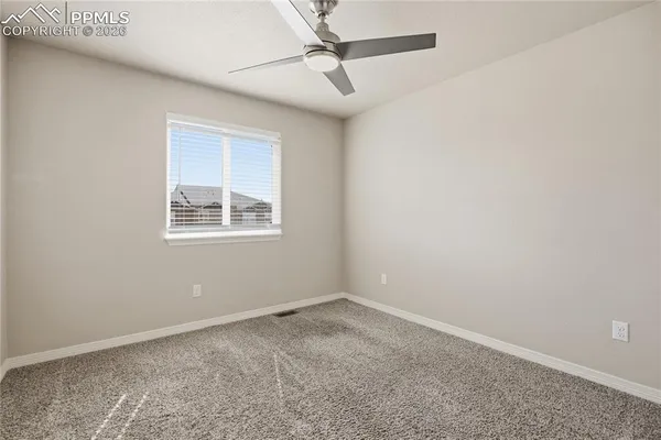 an empty room with closet and a bathroom