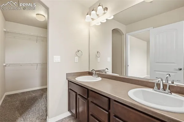 a bathroom with a granite countertop sink toilet and a mirror