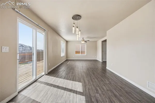 a view of a room with wooden floor and windows