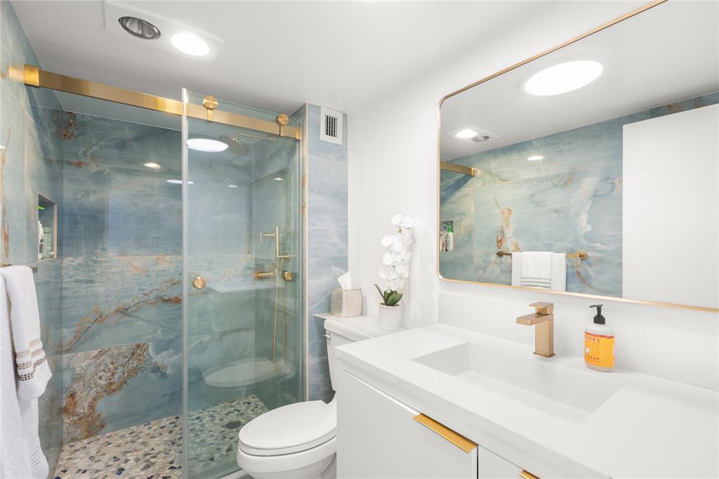 2000 South Ocean Boulevard, Unit 5D Lauderdale-by-the-Sea, FL 33062 - Photo 16 of 27 a bathroom with a sink vanity granite toilet and shower