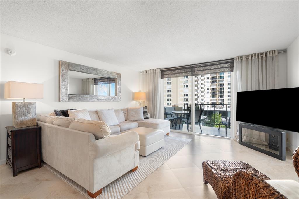 2000 South Ocean Boulevard, Unit 5D Lauderdale-by-the-Sea, FL 33062 - Photo 18 of 27 a living room with furniture a flat screen tv and a large window