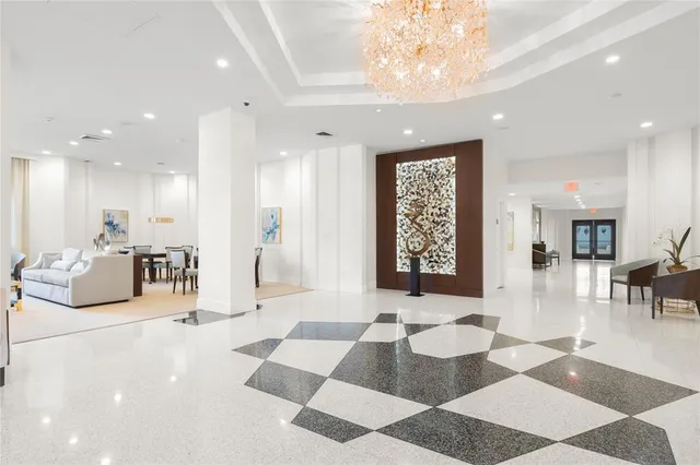 a view of a dining room with furniture and chandelier