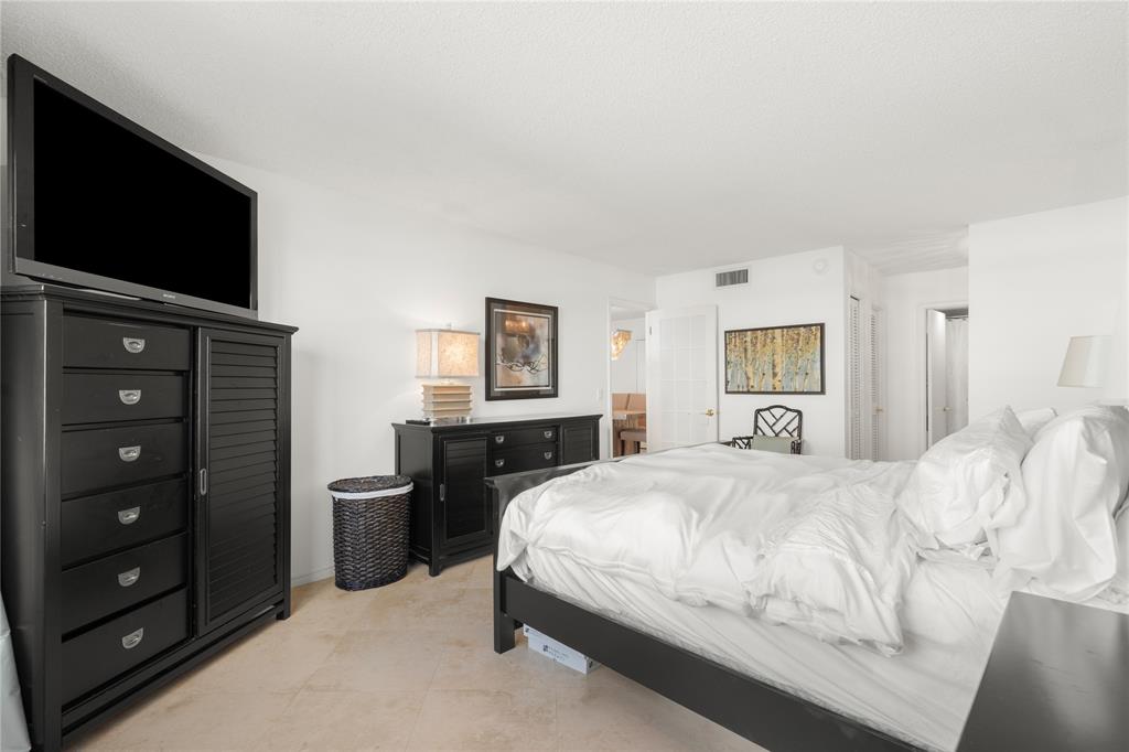 2000 South Ocean Boulevard, Unit 5D Lauderdale-by-the-Sea, FL 33062 - Photo 8 of 27 a bedroom with a bed and a flat screen tv