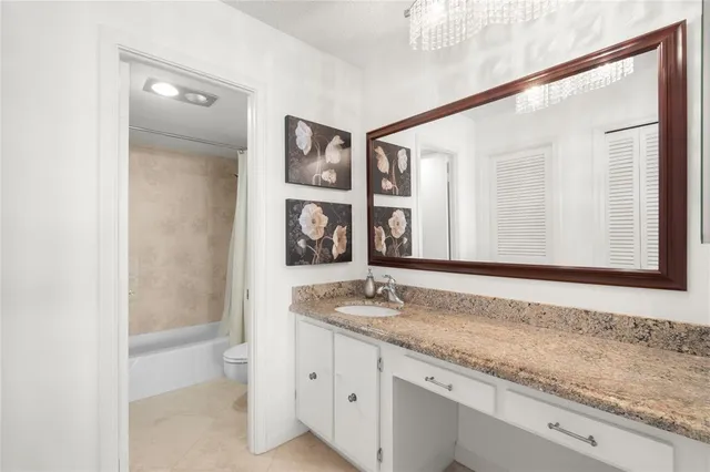 a living room with furniture a flat screen tv and a large window