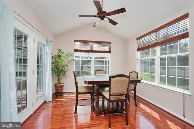 a dining room with furniture window and wooden floor