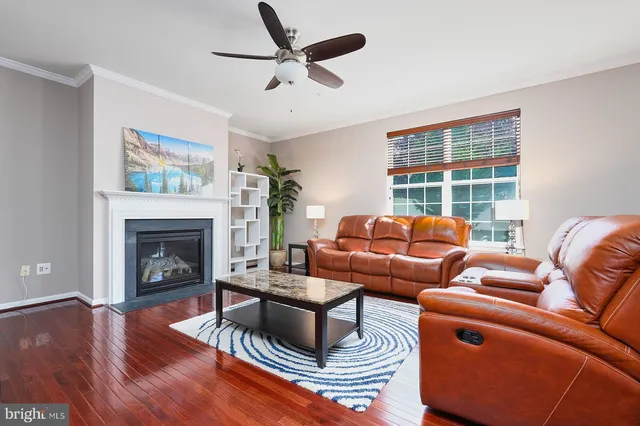 a living room with furniture a fireplace and a large window