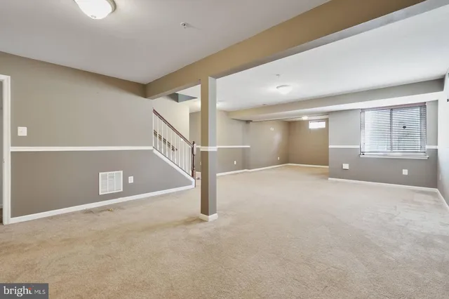 a view of an empty room with windows